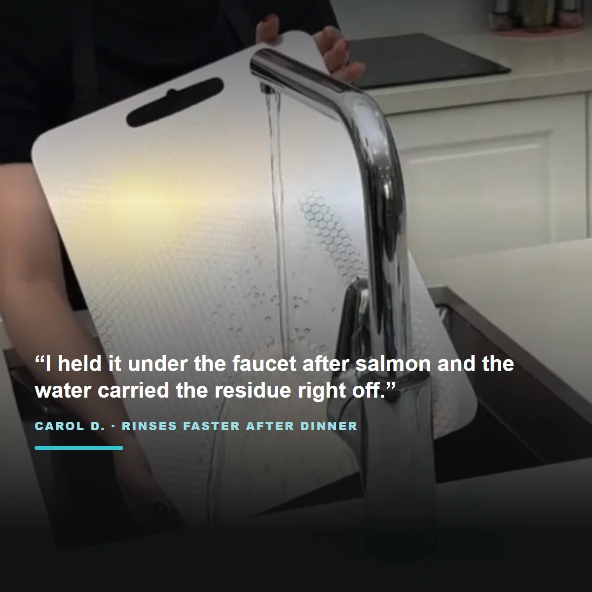 Customer rinsing a titanium cutting board under the faucet